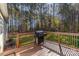 Outdoor wooden deck features a grill, perfect for enjoying the wooded backyard at 360 Lauren Pines Dr, York, SC 29745