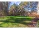 Large backyard with deck and wooden fence, surrounded by trees at 360 Lauren Pines Dr, York, SC 29745