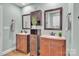 Double vanity bathroom with dark wood cabinets and a large mirror at 360 Lauren Pines Dr, York, SC 29745