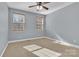 Bedroom featuring neutral carpet, ceiling fan, and natural light from the two windows at 360 Lauren Pines Dr, York, SC 29745