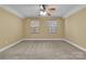 Bedroom featuring neutral carpet, ceiling fan, and natural light from the two windows at 360 Lauren Pines Dr, York, SC 29745