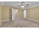 Bright bedroom with carpet flooring, ceiling fan, and access to closets and bathroom at 360 Lauren Pines Dr, York, SC 29745