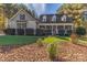 House exterior featuring a two-story home with a wraparound porch, landscaping, and stone accents at 360 Lauren Pines Dr, York, SC 29745