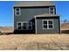 Rear view of a two-story house with dark siding and a small yard at 362 Brinkley Dr # 142, Kings Mountain, NC 28086