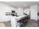 Modern white kitchen with island, stainless steel appliances, and hardwood floors at 362 Brinkley Dr # 142, Kings Mountain, NC 28086