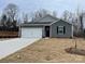 Gray exterior house with white garage door and landscaping at 404 Brinkley Dr # 141, Kings Mountain, NC 28086