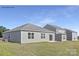 Rear view of a gray house and neighboring houses, showcasing a backyard at 404 Brinkley Dr # 141, Kings Mountain, NC 28086