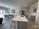 Modern kitchen with gray cabinets, white countertops, and island with seating at 404 Brinkley Dr # 141, Kings Mountain, NC 28086