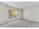 Spacious bedroom with large window and plush carpeting at 513 N Graham St # 3D, Charlotte, NC 28202