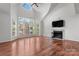 Living room with hardwood floors, fireplace and large windows at 513 N Graham St # 3D, Charlotte, NC 28202