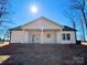 White house exterior with a large covered porch and spacious backyard at 723 E Memorial Hwy, Harmony, NC 28634