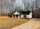 Newly built home with white siding, black roof, and stone accents at 723 E Memorial Hwy, Harmony, NC 28634