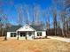 New construction home with white siding, stone accents and a light blue door at 723 E Memorial Hwy, Harmony, NC 28634