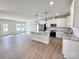 Modern kitchen with white cabinets, granite counters, and stainless steel appliances at 723 E Memorial Hwy, Harmony, NC 28634