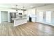 Open kitchen boasts white cabinets, granite countertops, and stainless steel appliances at 723 E Memorial Hwy, Harmony, NC 28634