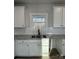 Kitchen boasts white shaker cabinets, granite countertops and subway tile backsplash at 723 E Memorial Hwy, Harmony, NC 28634