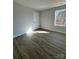 Bright bedroom with wood-look floors and a large window at 737 E Memorial Hwy, Harmony, NC 28634