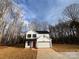 Two-story house with white siding, black accents, and a red door at 737 E Memorial Hwy, Harmony, NC 28634