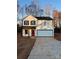 Two-story home with white siding, black accents, and a red front door at 737 E Memorial Hwy, Harmony, NC 28634