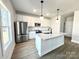 Modern kitchen with white cabinets, granite island, and stainless steel appliances at 737 E Memorial Hwy, Harmony, NC 28634