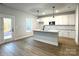 Modern kitchen with white cabinets, granite countertops, and an island at 737 E Memorial Hwy, Harmony, NC 28634