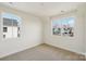 Bedroom with two windows providing natural light and views of the surrounding neighborhood at 809 Terra Dr, Tega Cay, SC 29708