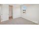 Bright bedroom featuring neutral carpet, a window with a view, and closet space at 809 Terra Dr, Tega Cay, SC 29708