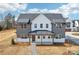 Charming two-story home featuring a covered entryway, complemented by professional landscaping and a paved walkway at 809 Terra Dr, Tega Cay, SC 29708