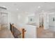 Upstairs hallway features carpet flooring, wood railing and multiple doorways at 809 Terra Dr, Tega Cay, SC 29708