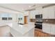 Modern kitchen featuring white cabinets, stainless steel appliances, and a large center island at 809 Terra Dr, Tega Cay, SC 29708