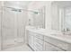 Modern bathroom featuring double vanity sinks, a large glass-enclosed shower, and marble countertops at 821 Terra Dr, Tega Cay, SC 29708