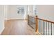 Upstairs hallway featuring hardwood floors, neutral paint, and natural light from nearby windows at 821 Terra Dr, Tega Cay, SC 29708