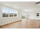 Bright and airy living room with natural light, hardwood floors, and serene backyard views at 821 Terra Dr, Tega Cay, SC 29708