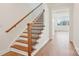 Elegant wooden staircase with iron spindles leads to the upper level, showcasing craftsmanship at 821 Terra Dr, Tega Cay, SC 29708