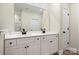 Bathroom featuring a double sink vanity with a large mirror and modern black fixtures at 1436 Panther Rd, Lancaster, SC 29720