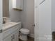 Stylish half bathroom features a modern vanity with light countertops, complemented by sleek hardware and a clean, contemporary design at 2014 Crown Point Dr # 2008-B, Albemarle, NC 28001