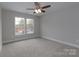 Bedroom with neutral paint, carpet, and two bright windows that offer a view of the outside at 2014 Crown Point Dr # 2008-B, Albemarle, NC 28001