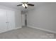 Bedroom with neutral carpet, paint and a ceiling fan as well as a closet and a door that leads to another room at 2014 Crown Point Dr # 2008-B, Albemarle, NC 28001