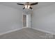 Bedroom with neutral paint, carpet, a ceiling fan with light, and two doors at 2014 Crown Point Dr # 2008-B, Albemarle, NC 28001
