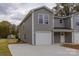 Two-story home featuring gray siding, a driveway, a covered porch, and an attached two-car garage at 2014 Crown Point Dr # 2008-B, Albemarle, NC 28001