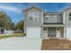 Attractive townhouse showcases a neutral gray exterior, inviting front porch seating, and a convenient attached garage at 2014 Crown Point Dr # 2008-B, Albemarle, NC 28001