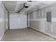 Spacious unfinished garage with concrete floor, garage door, utility box and lighting at 2014 Crown Point Dr # 2008-B, Albemarle, NC 28001