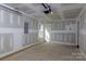 Spacious, unfinished garage with concrete floors, drywall, a window, and a door at 2014 Crown Point Dr # 2008-B, Albemarle, NC 28001