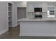 Bright kitchen features white cabinets, stainless appliances, and quartz countertops at 2014 Crown Point Dr # 2008-B, Albemarle, NC 28001