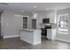 Modern kitchen features white cabinets, stainless steel appliances, and center island at 2014 Crown Point Dr # 2008-B, Albemarle, NC 28001