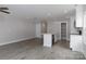 Open-concept living room features light gray walls, hardwood floors, and a modern kitchen island with stainless steel appliances at 2014 Crown Point Dr # 2008-B, Albemarle, NC 28001