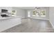 Spacious living room with natural light, kitchen island, and durable laminate flooring at 2014 Crown Point Dr # 2008-B, Albemarle, NC 28001