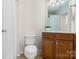 Bathroom features vanity with sink, toilet, and tiled flooring at 2100 Goddard Way, Waxhaw, NC 28173