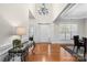 Bright foyer featuring hardwood floors, soaring ceilings, elegant chandelier, and a grand front door at 2100 Goddard Way, Waxhaw, NC 28173