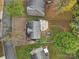 Aerial view of house, backyard, and surrounding trees. Features a patio and shed at 6934 Spring Morning Ln, Charlotte, NC 28227